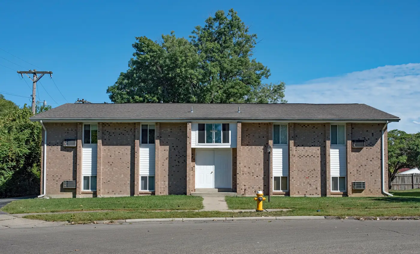 Apartment community with residents outside on a sunny day