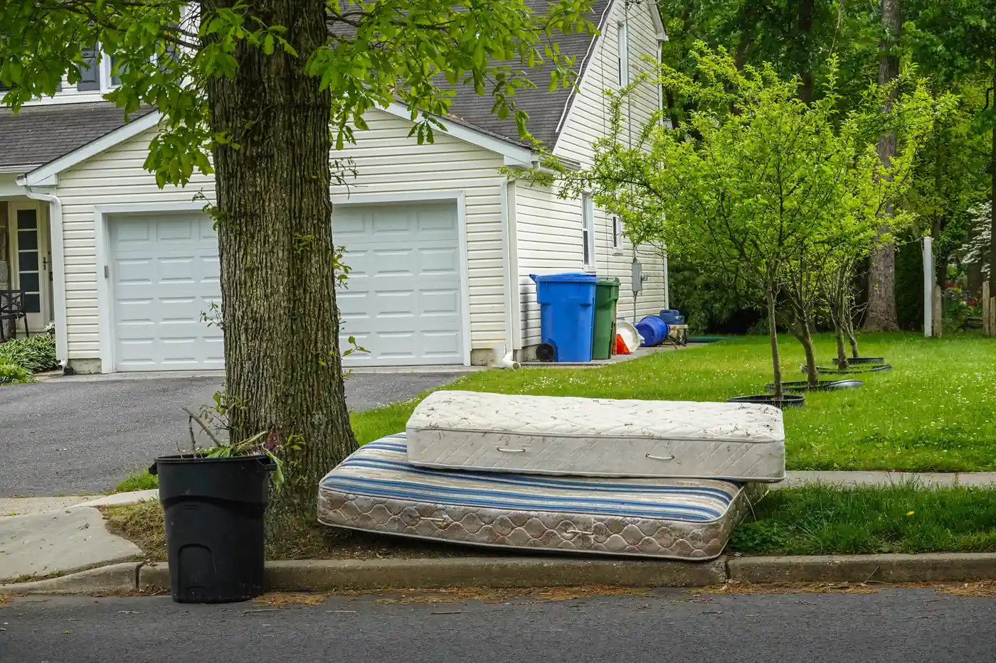 Two mattresses set out at the curb for bulk pickup