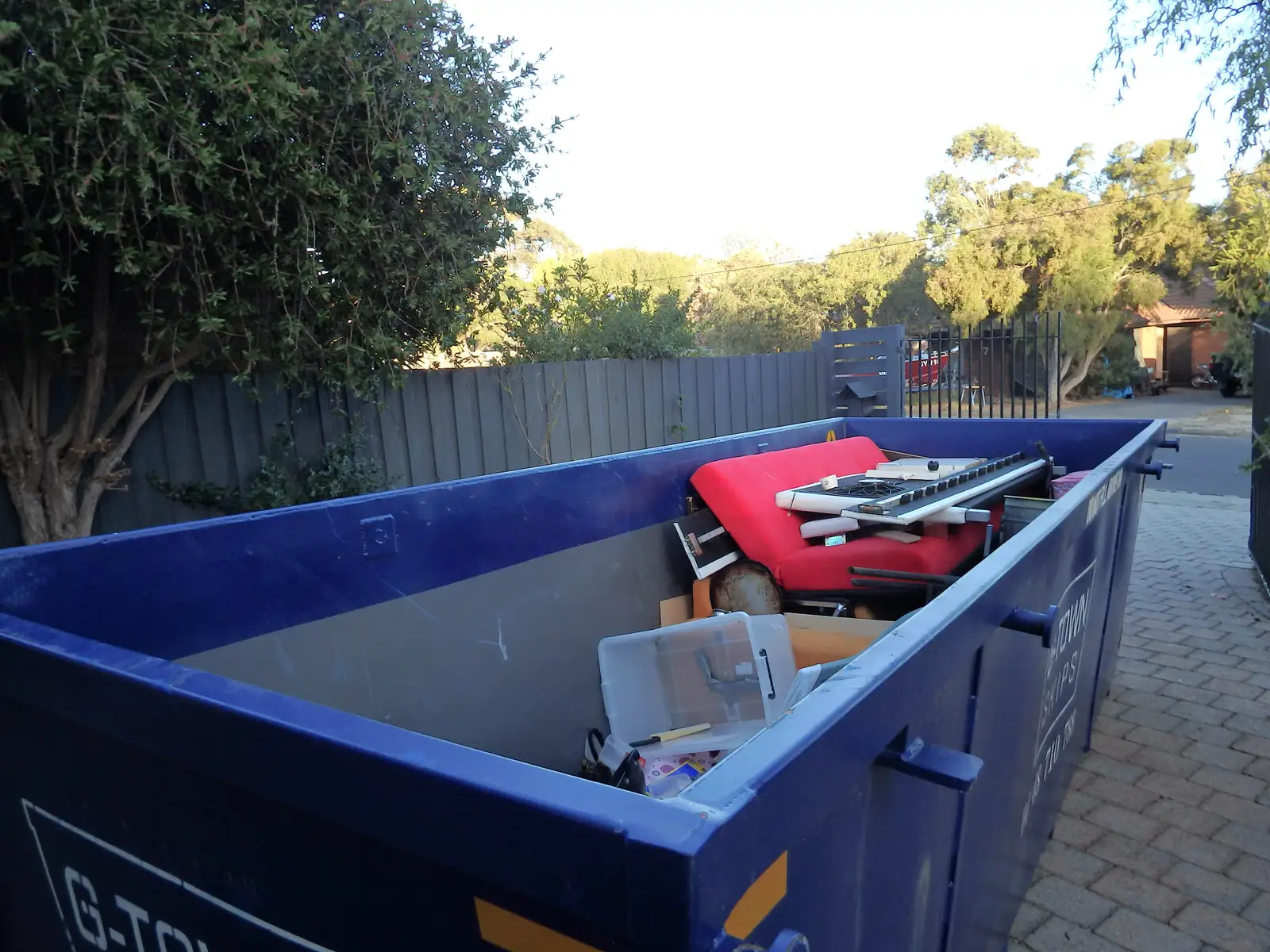 Roll-off container loaded with old furniture and household items